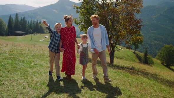 Family Enjoying Nature Walking on Mountain Hill