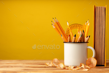 Metal cup with sharp pencils and pencil shavings on wooden desk / Photodune, Misc