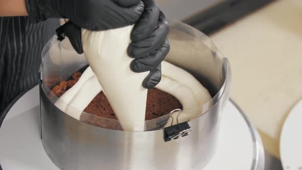 Confectioner Squeezes and Smears Vanilla Cream Onto Sponge Cake