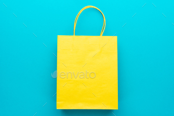 Top View Of Yellow Shopping Paper Bag On Blue Background / Photodune, Misc