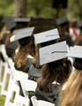 A group of students sit at a graduation ceremony, focus on mortarboard hat. - PhotoDune Item for Sale