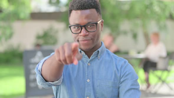 Portrait of African Man Pointing at Camera Inviting