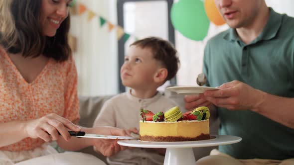 Happy Family Sharing Birthday Cake at Home