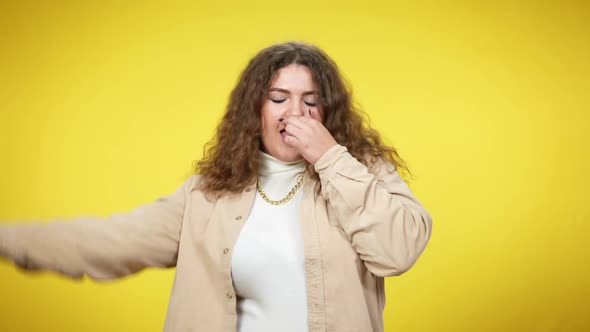 Cheerful Charming Plussize Woman Dancing at Yellow Background Sending Air Kiss