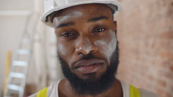 Close Up Portrait of Tired Man Construction Worker with Dirty Face Looking at Camera