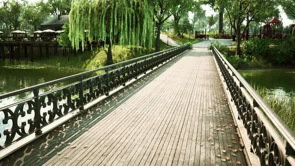 Old Metal Bridge Over a Small River in Park