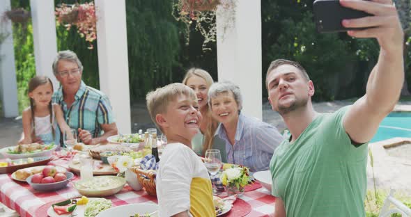 Happy family eating together at table