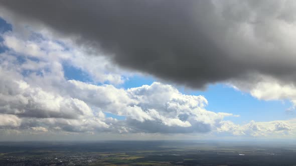 Aerial View at High Altitude of Earth Covered with Puffy Cumulus Clouds Forming Before Rainstorm