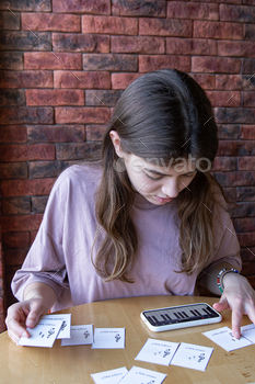 on her phone and educational cards.