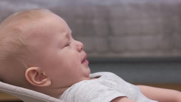 Caucasian 9Monthold Baby Boy is Upset and Crying Dad Handing Mobile Device to Child to Calm Him Down