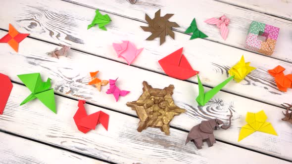 Set of Origami Objects on Rustic Wooden Background.