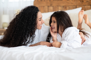 Beautiful mother and daughter in bathrobes laughing / Photodune, Misc