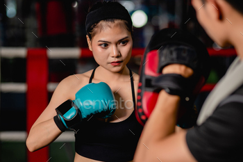Young fit woman doing exercise boxing with coach man / Photodune, Misc