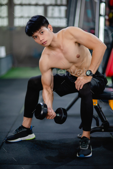 Young man bodybuilder lifting perform exercise with dumbbell / Photodune, Misc