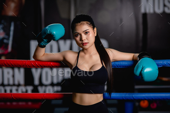Young beautiful woman boxer exercise resting on boxing ring / Photodune, Misc