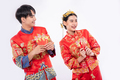 The Man and woman wear cheongsam glad to get the gift money from their relative in traditional day - PhotoDune Item for Sale
