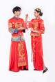 Men and women wearing cheongsam standing with red bags - PhotoDune Item for Sale
