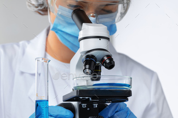 Close up photo of woman scientist working with microscope / Photodune, Misc