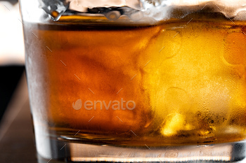Whisky glass against dark black grunge wall / Photodune, Misc