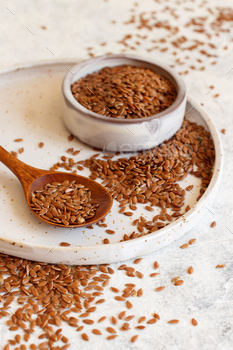 Plate of Raw Flax seeds with a spoon / Photodune, Misc