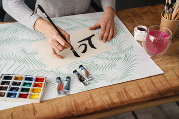 Calligrapher girl writing while working on valentines at table indoors / Photodune, Misc