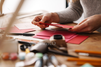 Calligrapher girl working on valentines at table indoors / Photodune, Misc