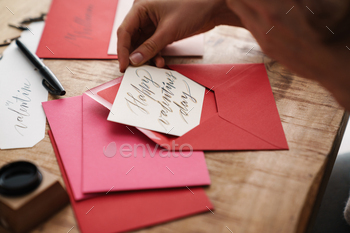 Calligrapher girl working on valentines at table indoors / Photodune, Misc