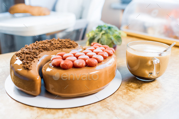 On an old wooden table there is a beautiful chocolate cake, a transparent cup with coffee and a / Photodune, Misc