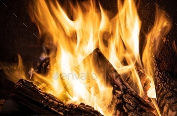Fire orange tongues on black background in a brick fireplace / Photodune, Misc