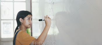 School child thinking while doing mathematics problem / Photodune, Misc