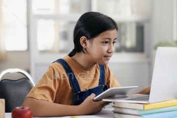 Happy asian girl learning online at home / Photodune, Misc