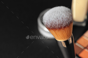 Professional makeup brushes and tools, make-up products set on dark table / Photodune, Misc