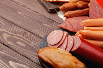 Variety of meat and sausage products on table / Photodune, Misc
