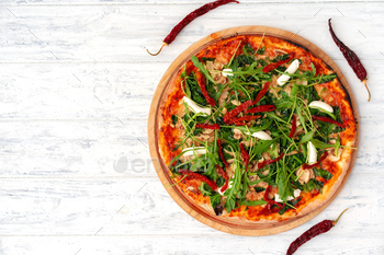 Fresh pizza with herbs and sun dried tomatoes on gray table / Photodune, Misc