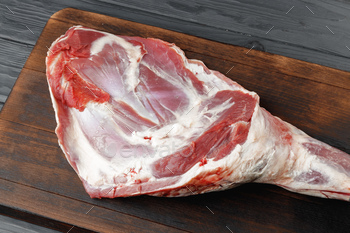 Raw beef leg on brown wooden board / Photodune, Misc