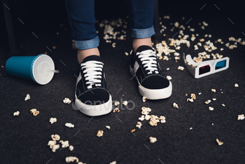 low section of female legs on messy floor in movie theater / Photodune, Misc