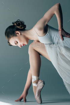young ballerina in white dress stretching in studio / Photodune, Misc