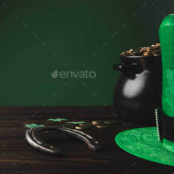 golden coins, horseshoe and green hat on wooden table, st patricks day concept / Photodune, Misc