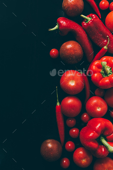 top view of red tomatoes, bell peppers and chili peppers on grey dark table / Photodune, Misc