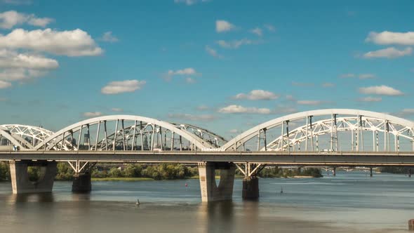 The Movement of Clouds Over the Bridge Along Which Cars and Trains, Time Lapse  Panorama