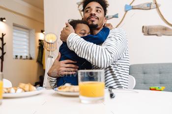 African american father and son hugging while having breakfast / Photodune, Misc