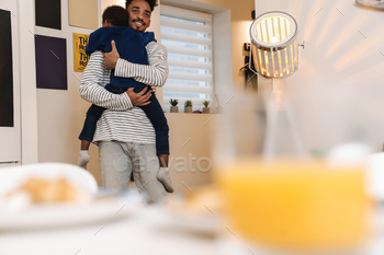Young african father holding his son while standing / Photodune, Misc