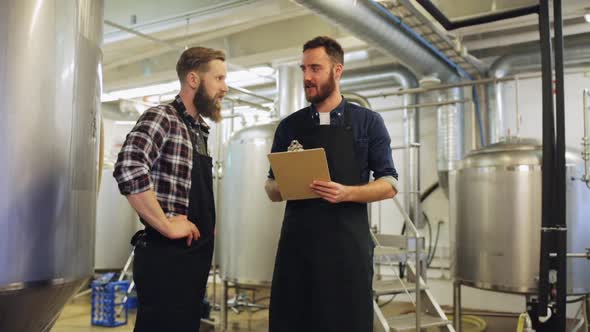 Brewers with Clipboard at Brewery or Beer Plant