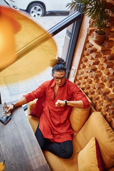 Top view of rich man in red and black clothes that sitting indoors in cafe with lot of money in hand / Photodune, Misc