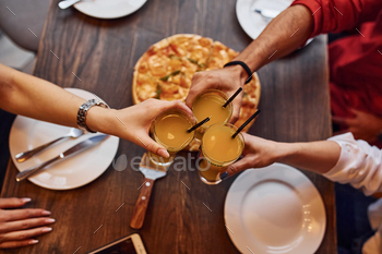 Close up view of people that taking and eating pizza indoors together / Photodune, Misc