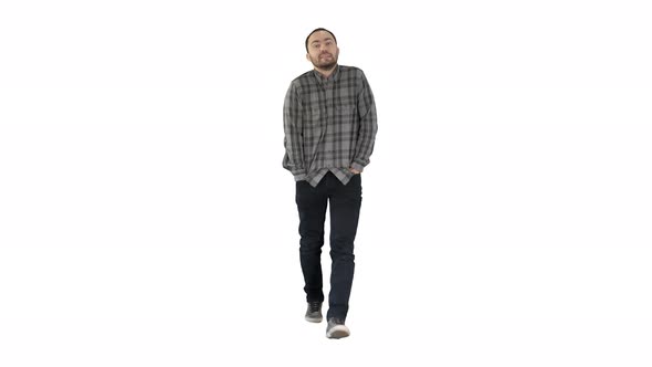 Young Man Walking with Hands in His Pockets and Whistles on White Background.