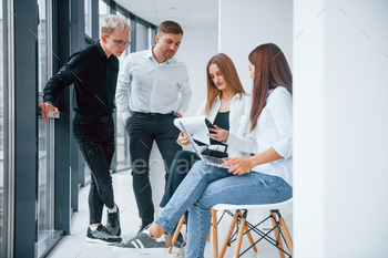 Group of young successful team sitting and working together indoors / Photodune, Misc
