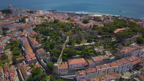 Aerial drone shot of Castle Sao Jorge with National Pantheon and alfama in background in Lisbon at s