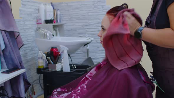 Young Woman Sits During Hair Care Procedure in Salon