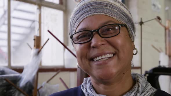 Mixed race woman working at a hat factory